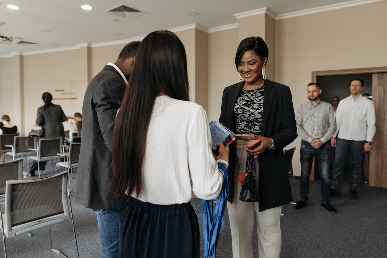 Professionals gathered in a modern conference room, engaging in a business meeting. Diverse group of participants.